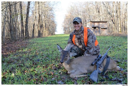 A hunter posing with her first deer