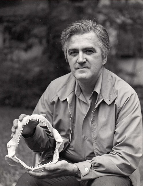 Gerard "Jerry" Case poses with a jaw fossil