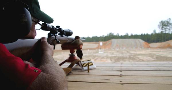 Man looking down rifle sight at McHenry Range